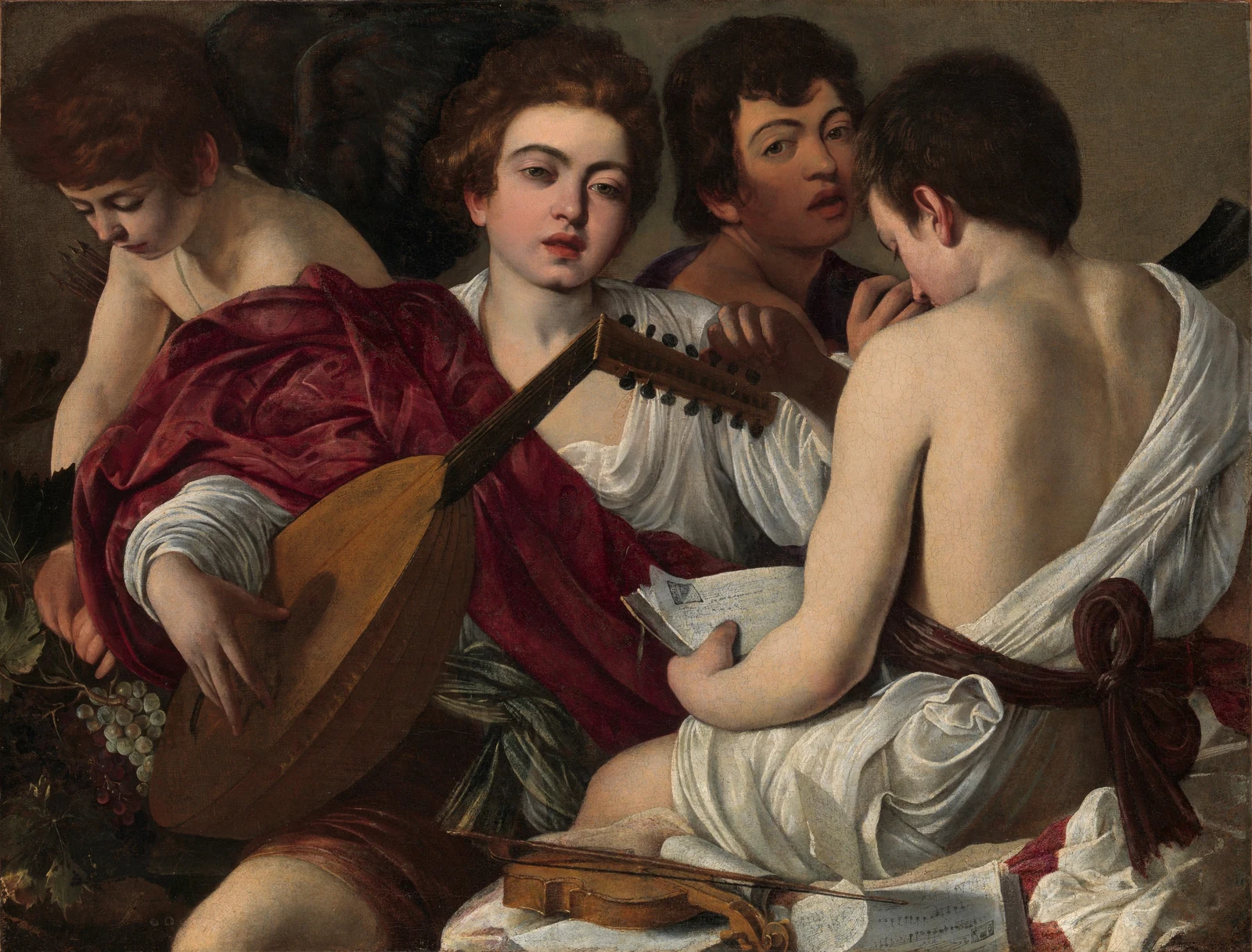 Pintura de Caravaggio: quatro jovens músicos; o do centro afina um alaúde.